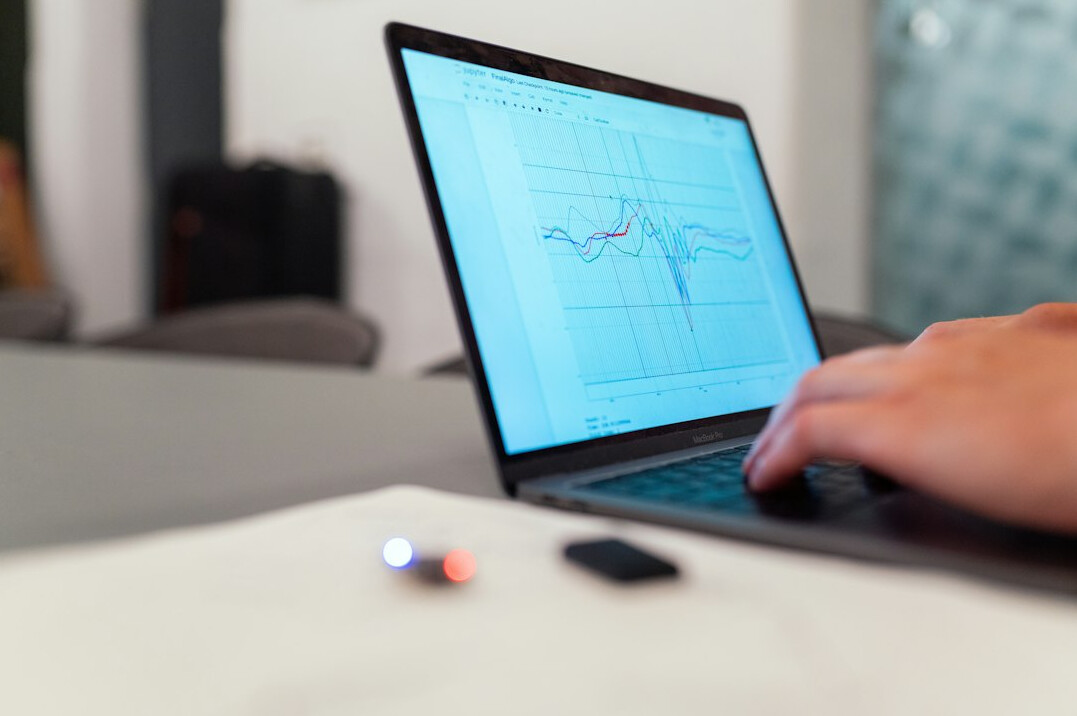 person checking stock prices on laptop