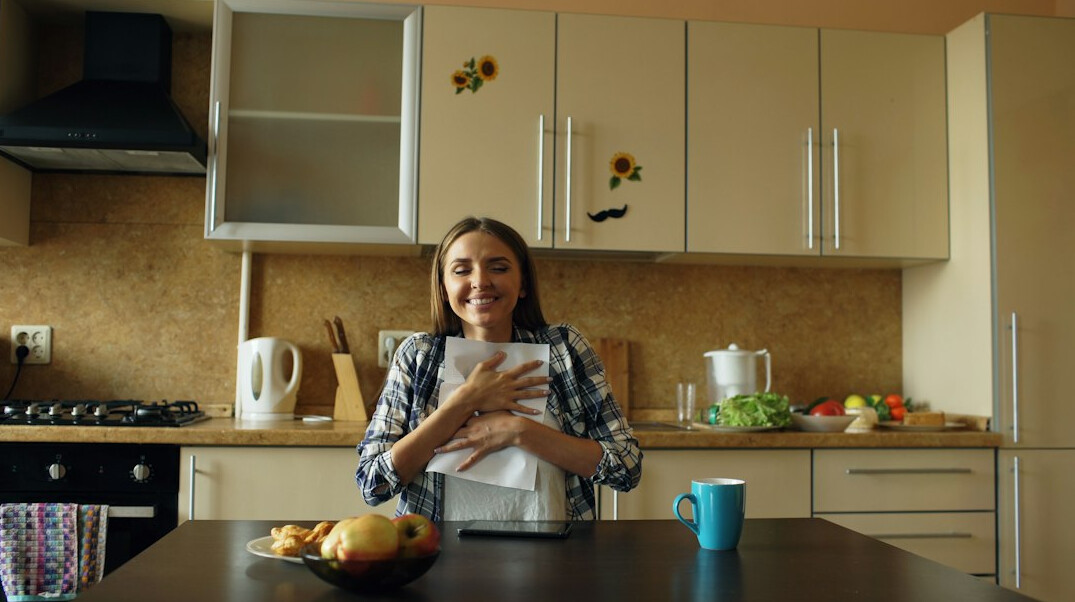person reviewing budget at kitchen table