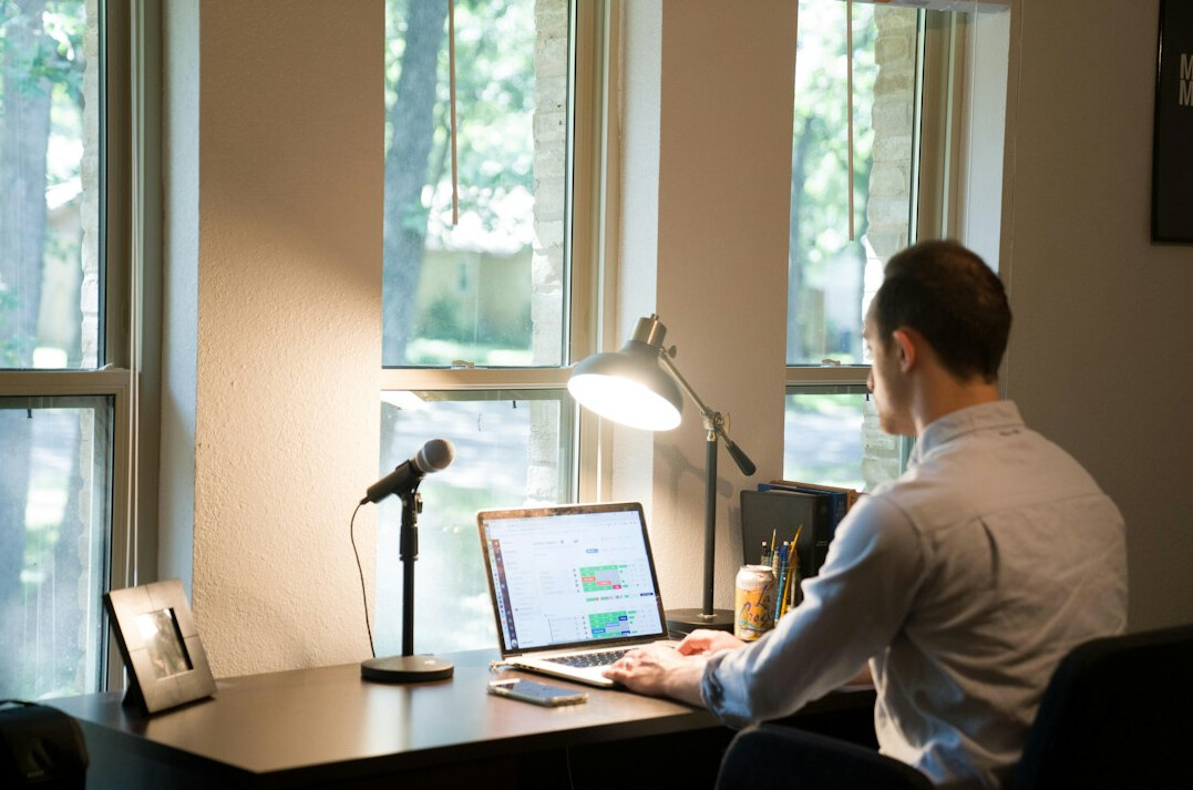 person budgeting at home desk