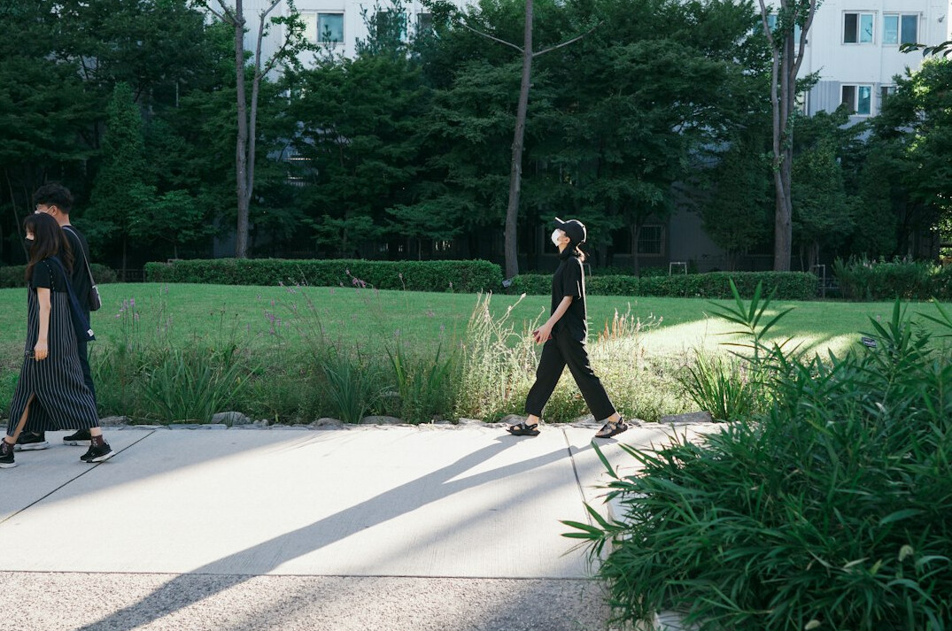 person walking in city park