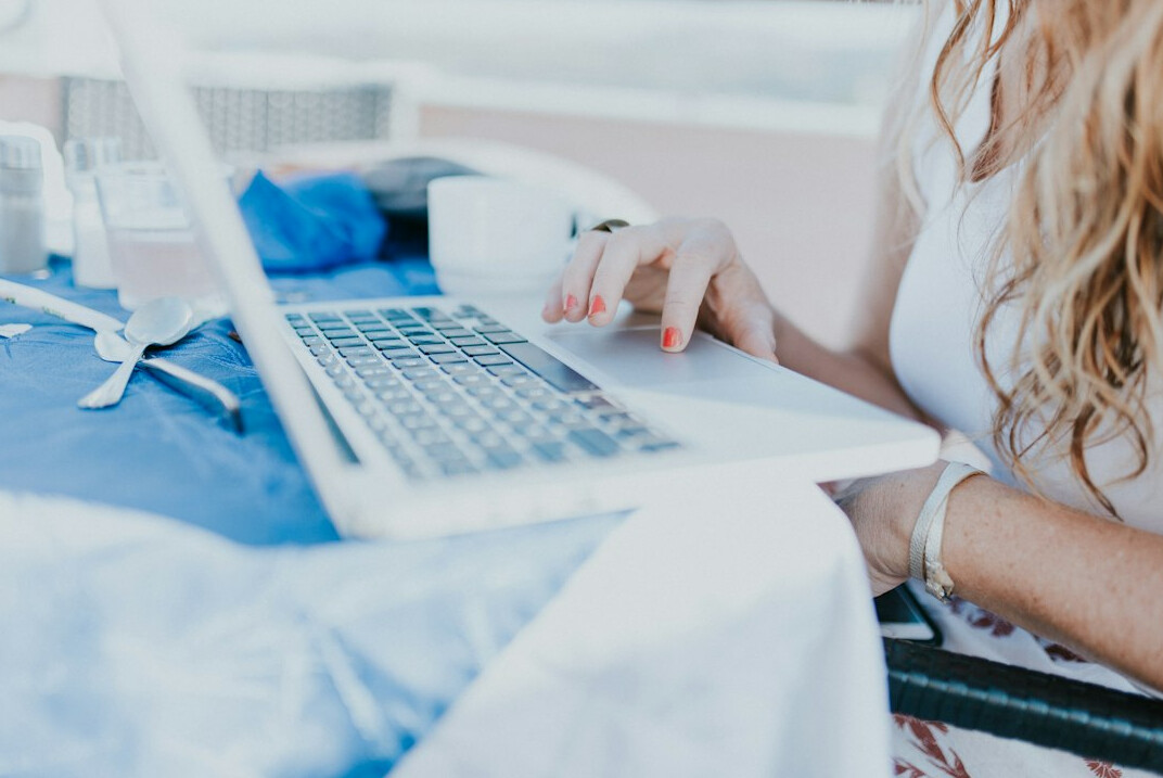 woman tracking expenses on laptop
